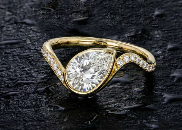 Asymmetric pear cut diamond engagement ring in white gold, handcrafted by Ian Davidson Calgary